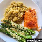 Air Fryer Salmon Served on white plate with Quinoa and asparagus