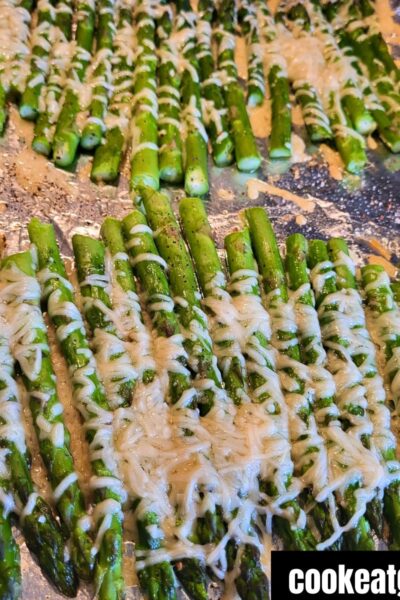 Oven Roasted Parmesan Asparagus on a cookie sheet covered in foil baked