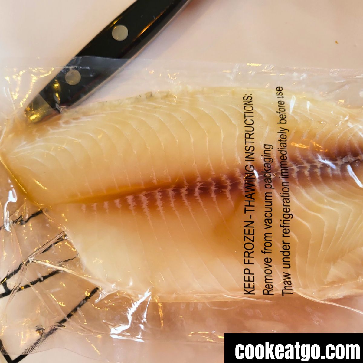 Tilapia fillet thawed on a plate in packaging