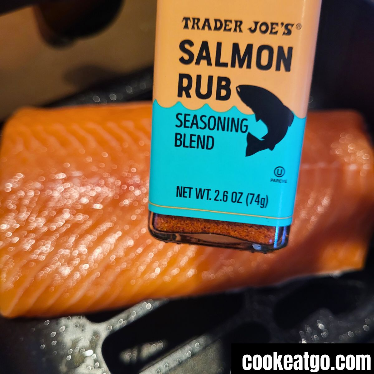 Trader Joes Salmon Rub above a fillet of salmon in air fryer basket