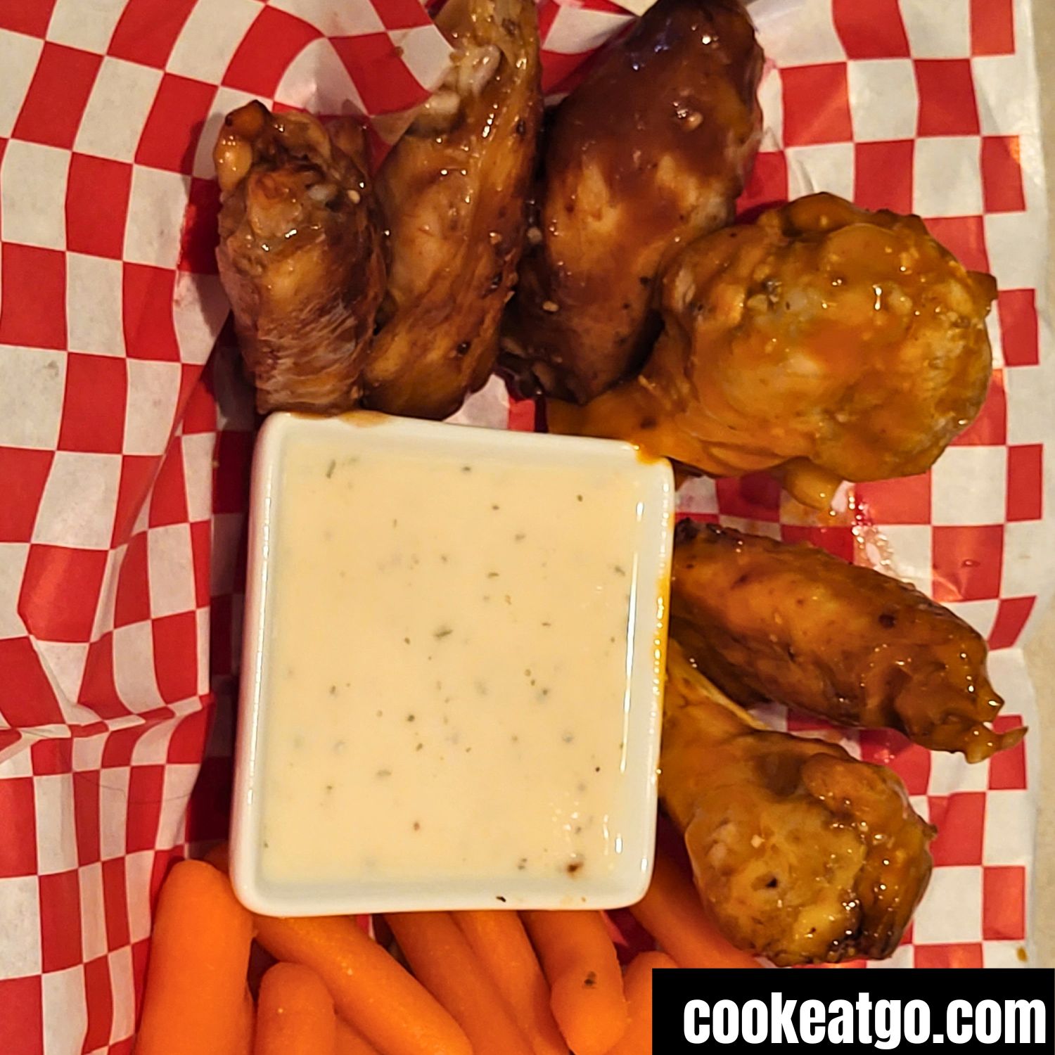 Air Fried Chicken Wings coated in sauce served with ranch and carrots