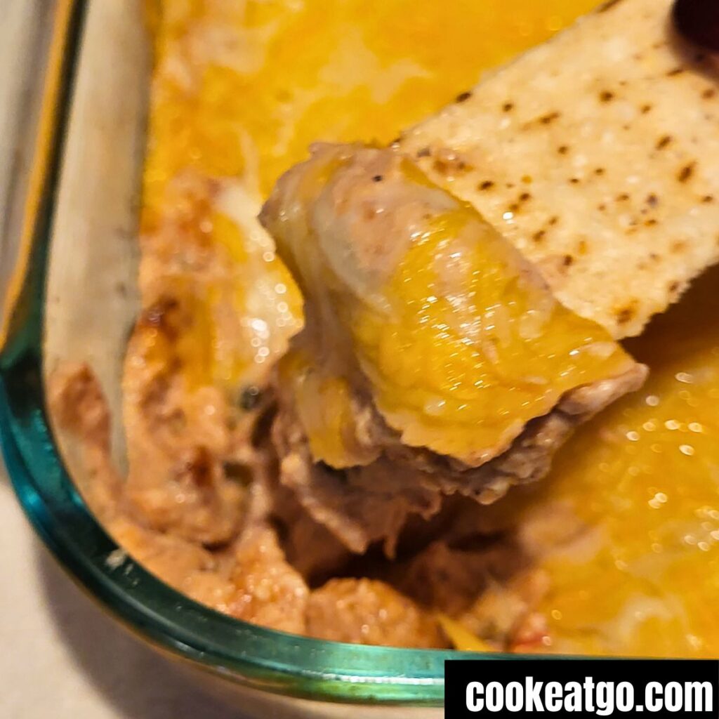 Cheesy Refried Beans on tortilla strip chip