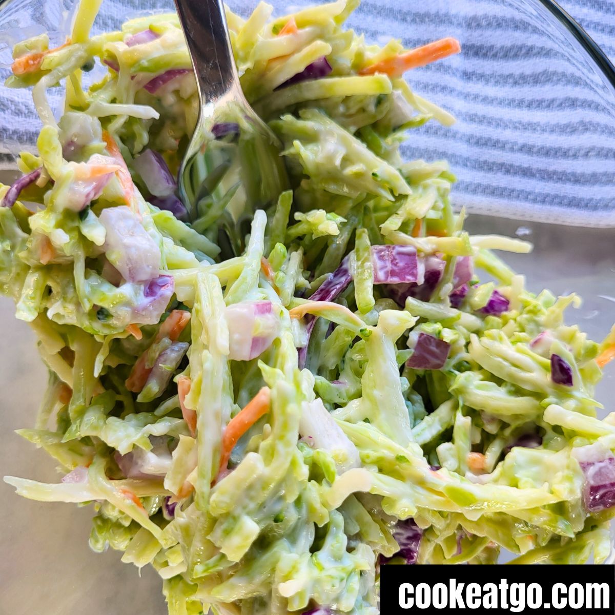 WW Broccoli Slaw Salad in a clear bowl with a fork