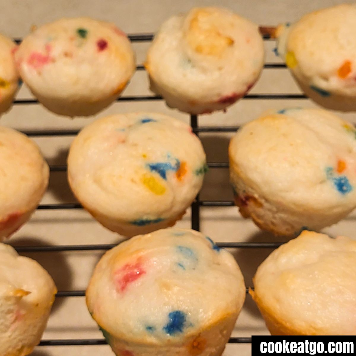 Baking rack with funfetiti muffins on it cooling
