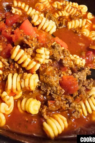 Cooked Crockpot Goulash topped with cooked radiator pasta cooked in
