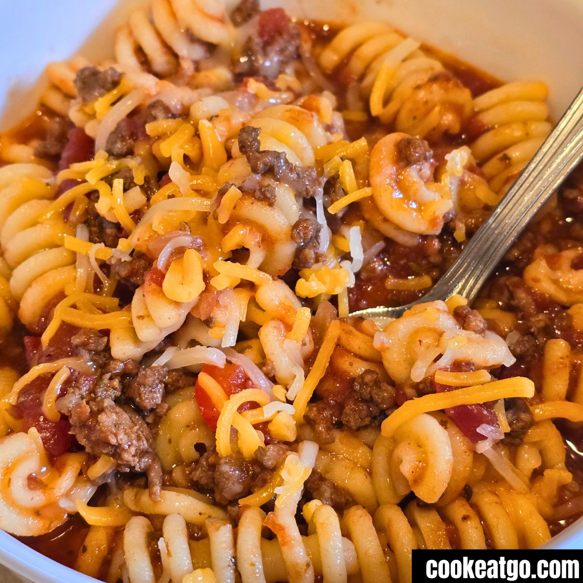 Slow cooker goulash served in a white bowl