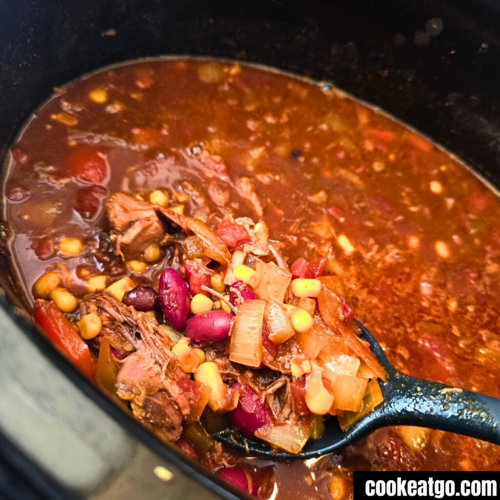 Slow Cooker Birria Chili cooked in crockpot with spoon