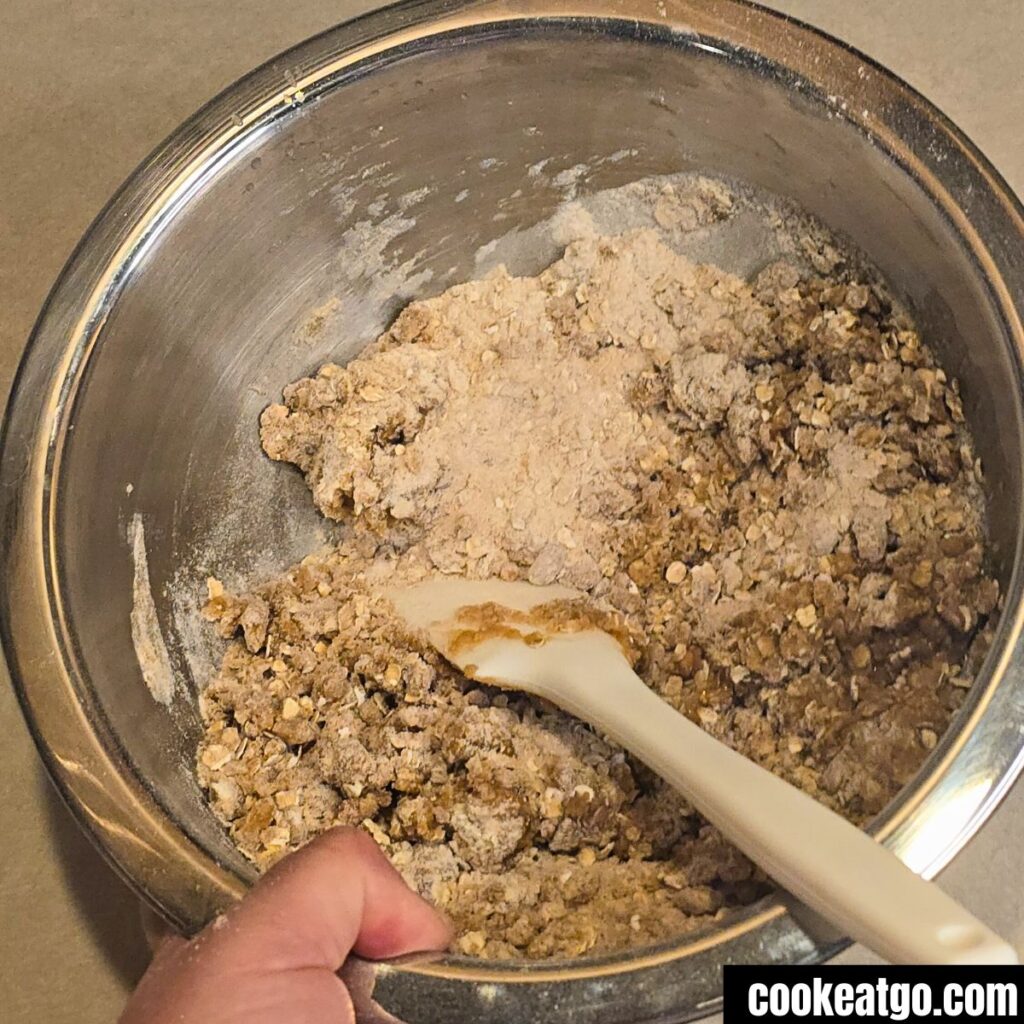 Brown Sugar Oat Topping for Peach Crisp in bowl mixing