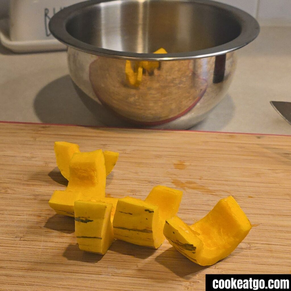Delicata Squash sliced into slices on a cutting board