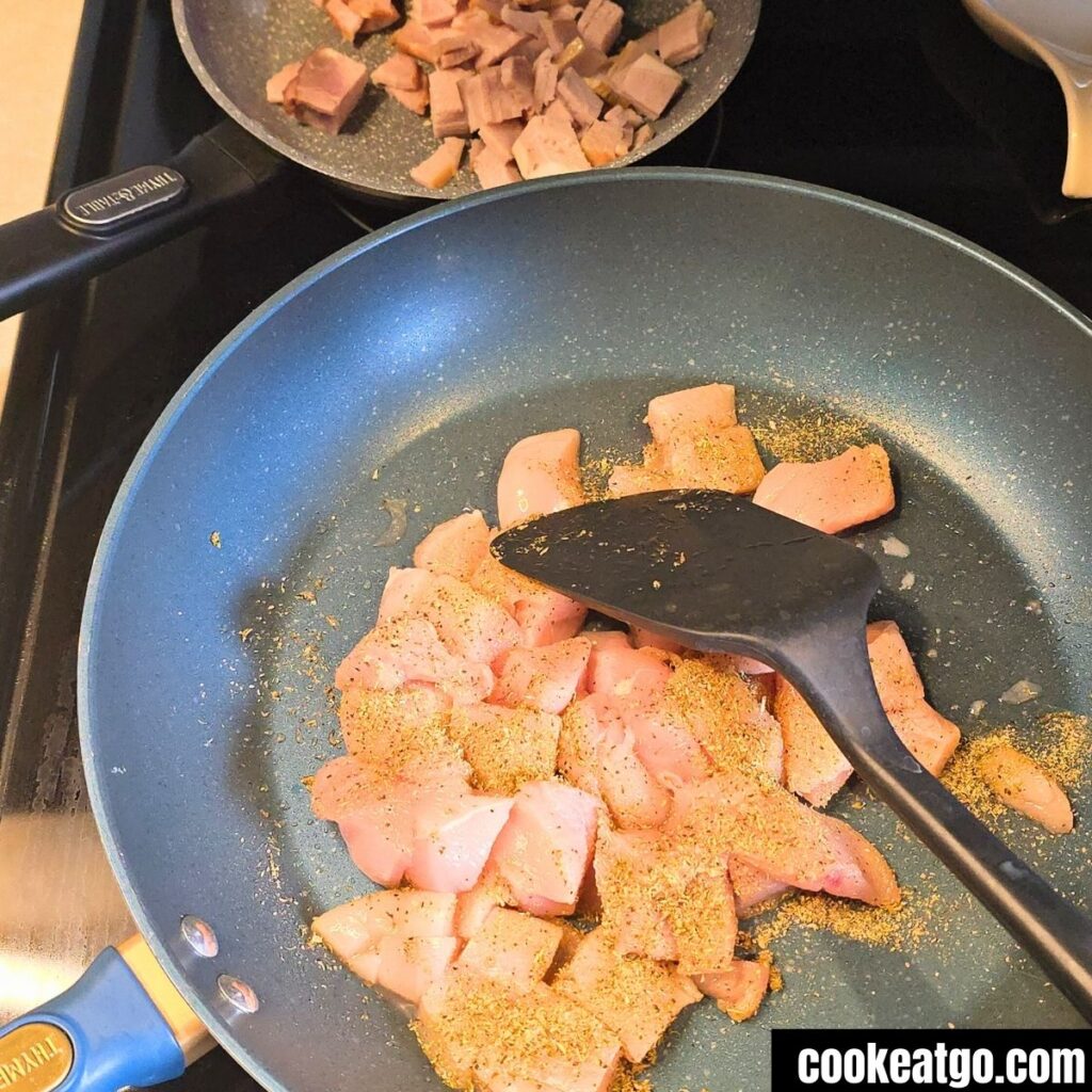 Chicken with Primal Palate Adobo seasoning cooking in skillet