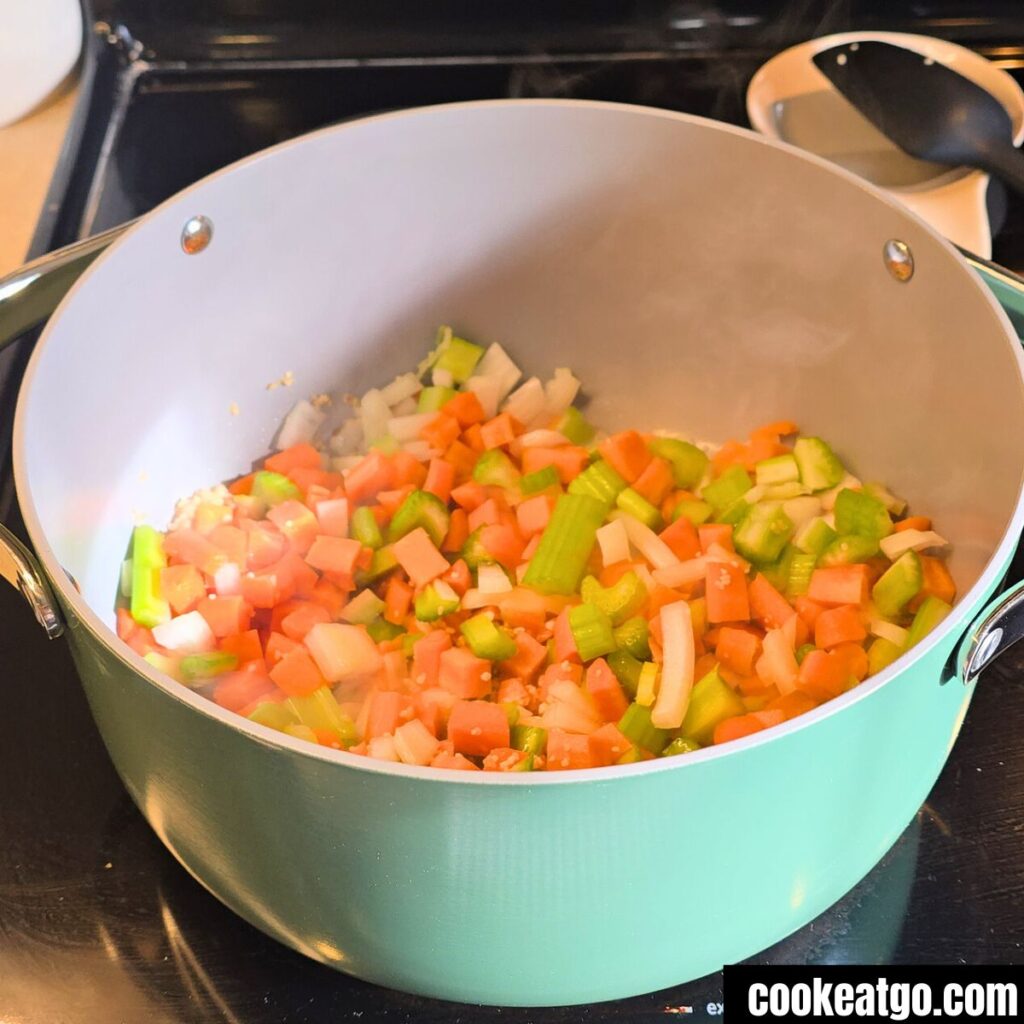 Vegetables for High Protein Chicken Noodle Soup cooking in Caraway dutch oven