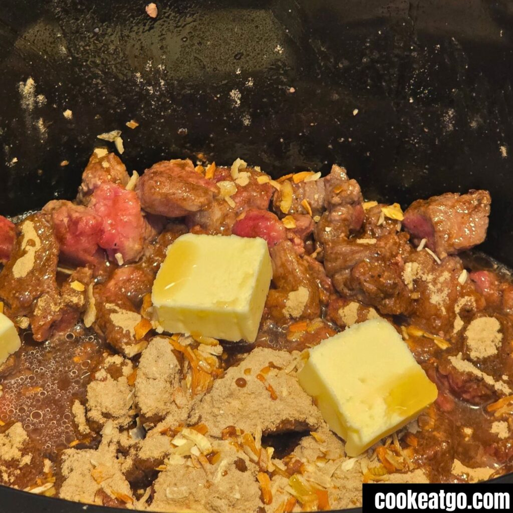 Stew meat Wtih Butter Chunks, aj ju gravy mix, and onion soup mix in crockpot