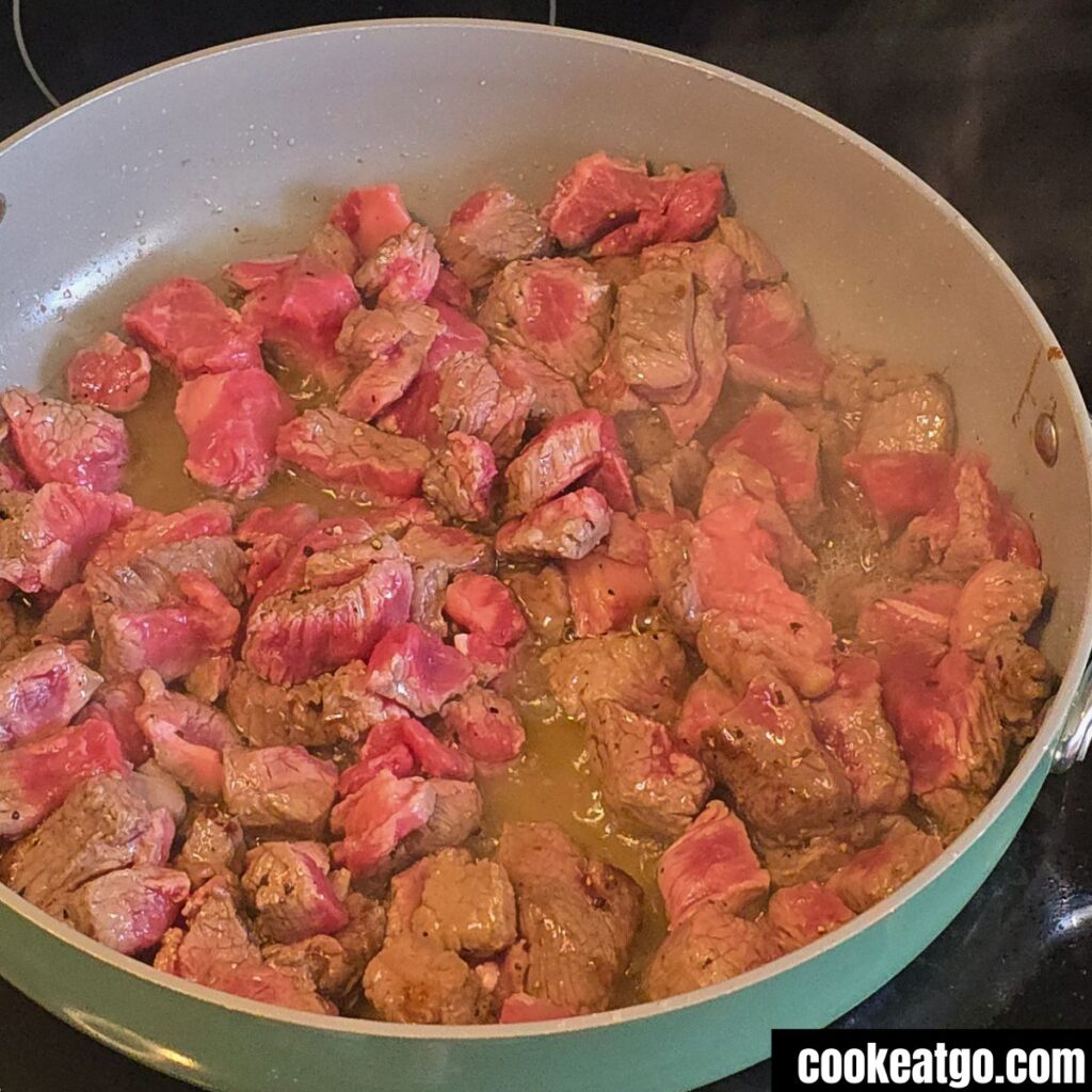 Stew Meat Sauting in Caraway Pan On Stove