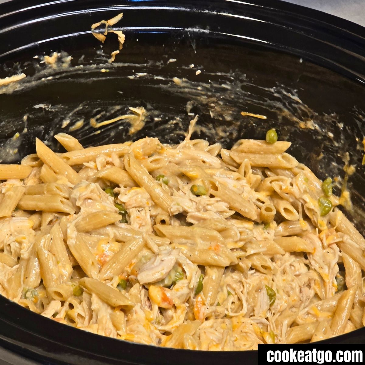 Slow Cooker Chicken Pot Pie Pasta mixed in crockpot