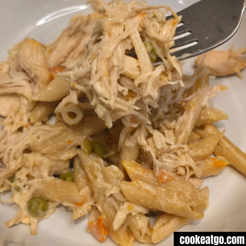 Slow Cooker Chicken Pot Pie Pasta on white plate with fork